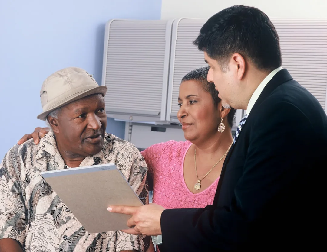 Family meeting with financial advisor reviewing estate planning documents