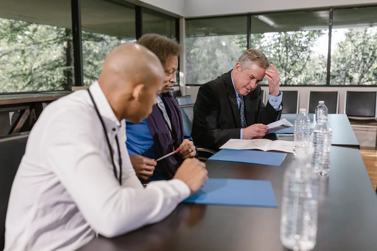Family members in a professional meeting discussing business transition