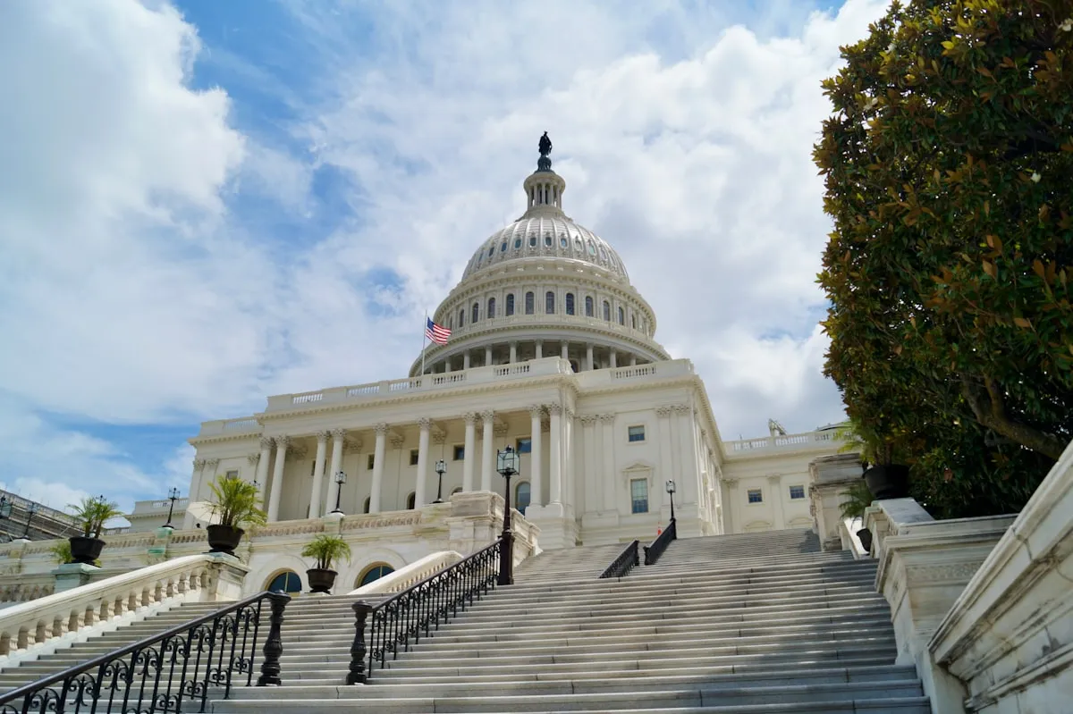 White concrete government building with pillars under blue sky