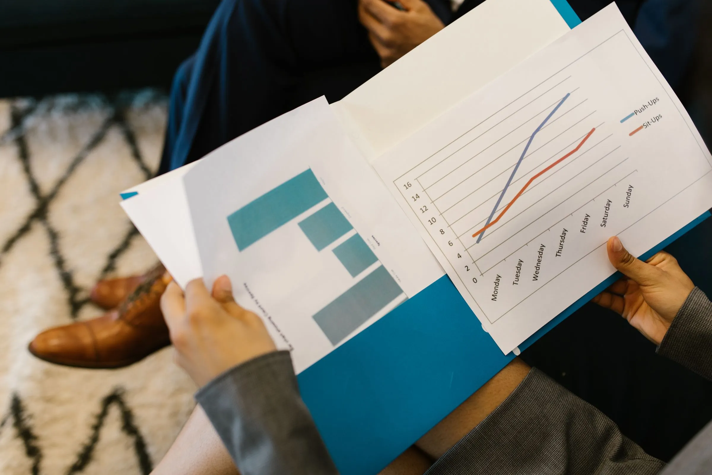 Business reports with financial graphs and data analysis documents on a corporate desk
