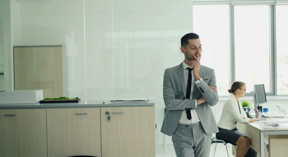Business professional contemplating a decision in a modern office