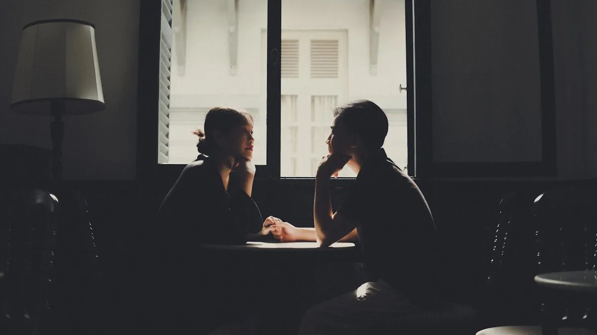 Two professionals in a thoughtful conversation about a business transition