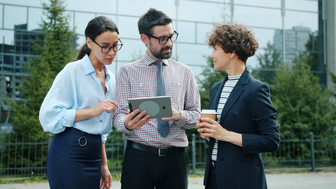 Professional presenting options on tablet device to client across desk