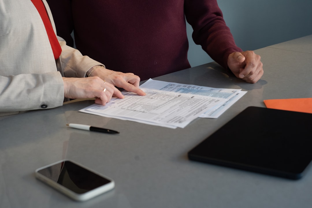 Contract signing at a desk with business documents in warm light