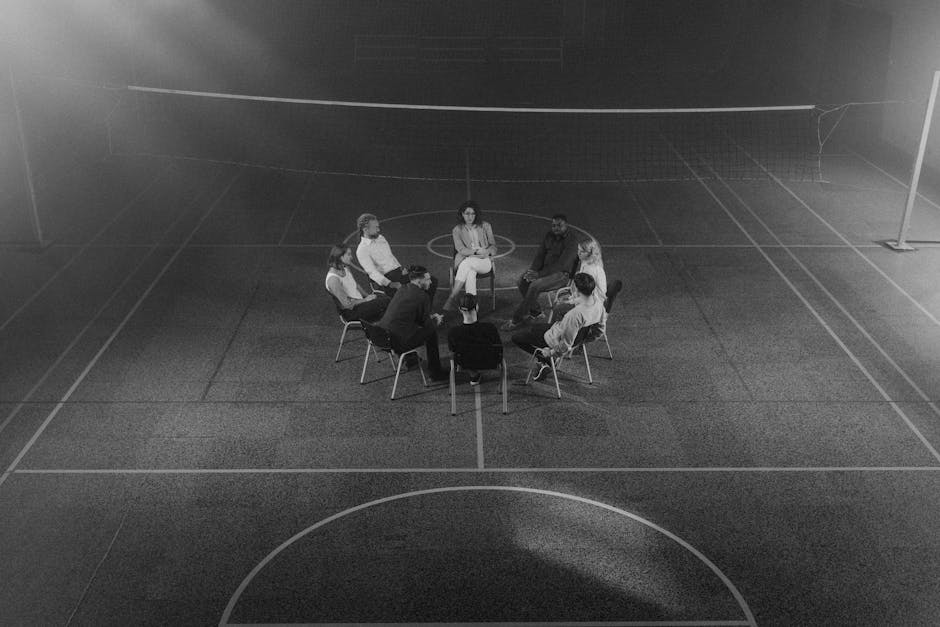 Small grief support group seated in a circle having a counseling conversation