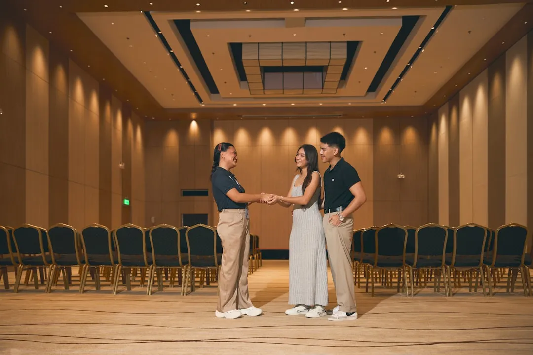 Two professionals shaking hands in a conference room closing a business deal