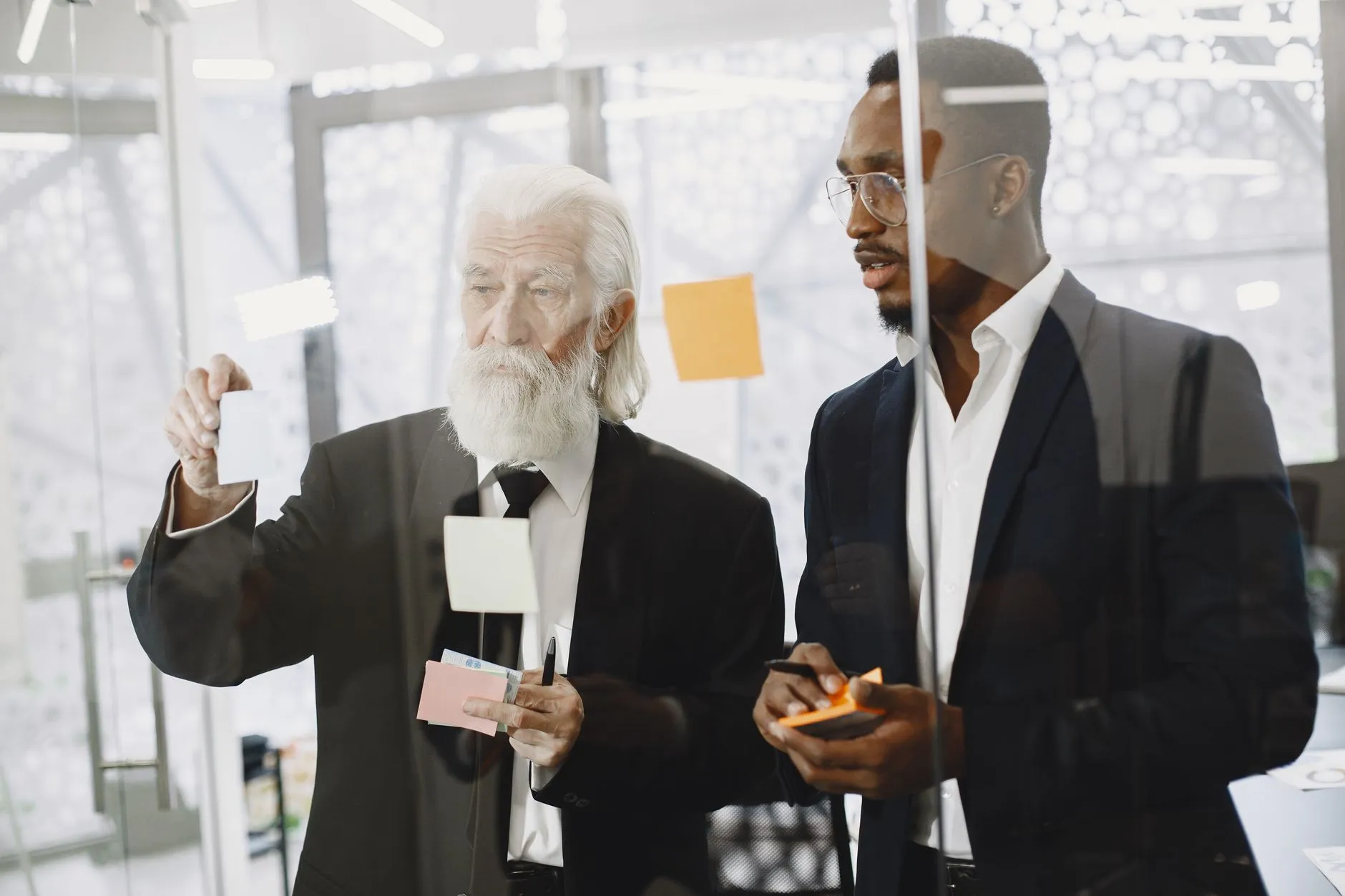 Multi-generational professionals in a business discussion representing the generational shift in consumer expectations