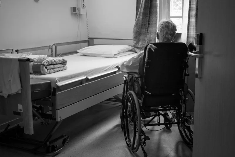 Senior care facility hallway with professional staff