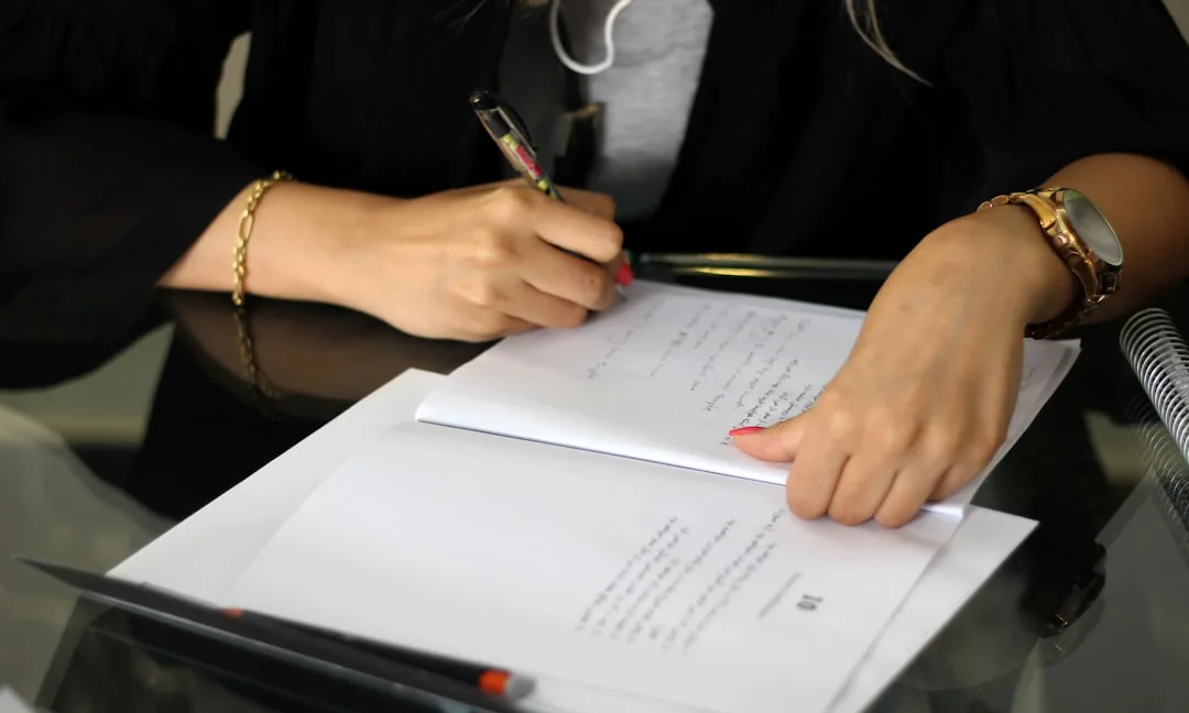 Attorney drafting legal documents at a professional desk